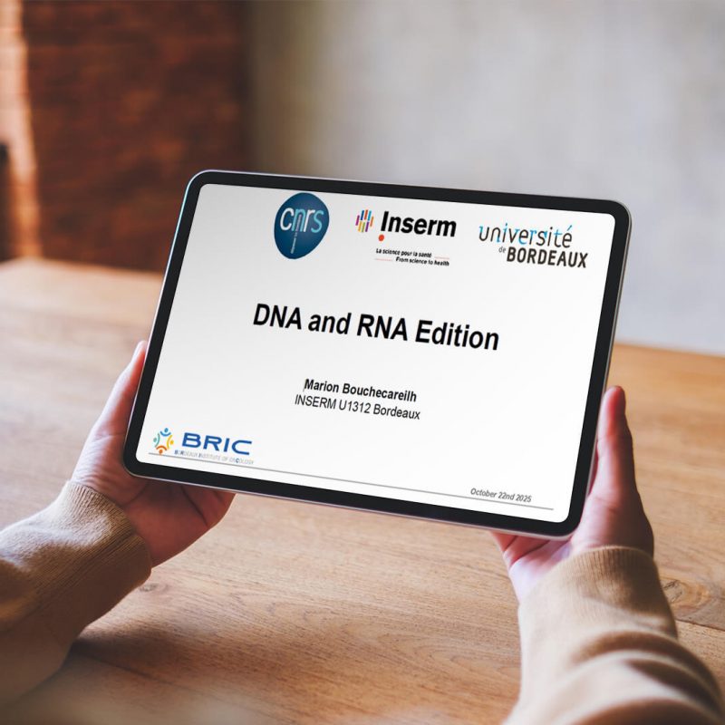 A person holds a tablet displaying a presentation titled "DNA and RNA Edition" by Marina Bouscharain, with logos of CNRS, Inserm, Université de Bordeaux, and BRIC visible.